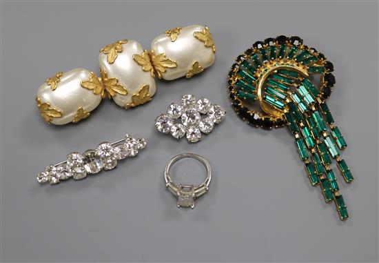 Two paste set brooches, a paste set dress ring and two other costume brooches.